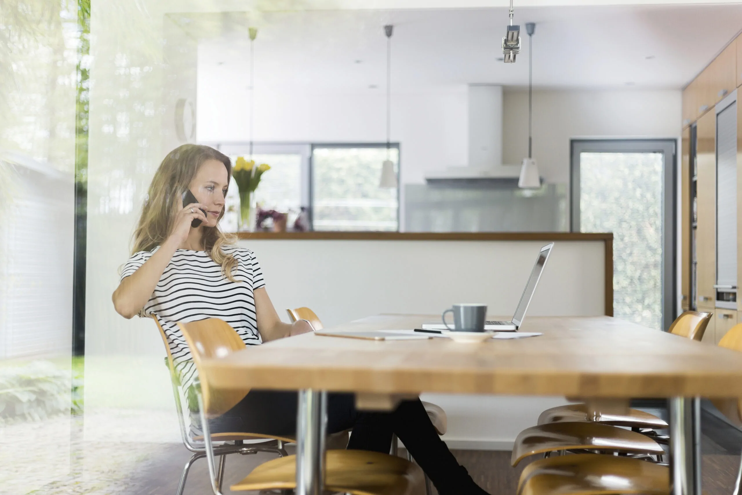 woman on cell phone sitting at table 2024 09 18 10 07 33 utc